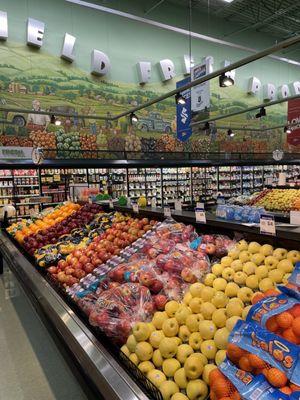 Exceptional displays of fresh fruits and vegetables, highlighted by the bright, colorful, murals on the walls!