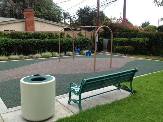 Swings for the kiddos on soft, bouncy recycled rubber stuff.