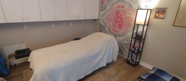 A massage table where sometimes therapeutic relaxation and/or sound healing and/or therapeutic touch take place