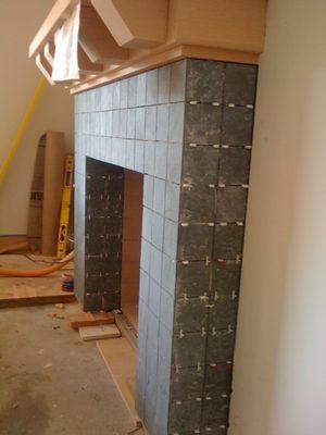 Natural tile installation on the fireplace