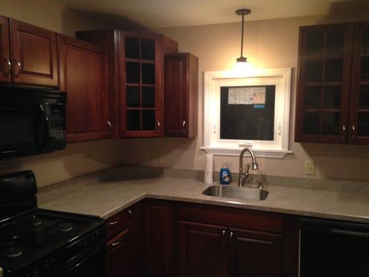 Kitchen remodel with new cabinets, ceramic tile, laminate countertops and replacement window with colonial casing.