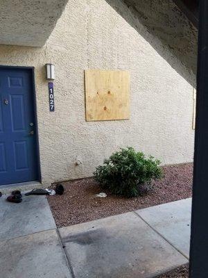 Trash left from neighbors and broken window from domestic despute that was left unfixed and boarded up for months.