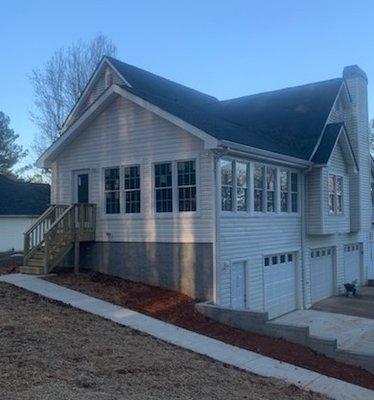 Expanded home into a 3-car parking garage with room addition on top. Also poured concrete driveway and sidewalk!