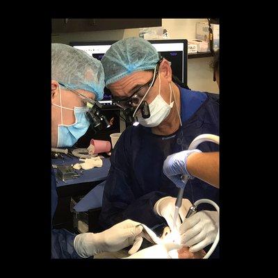 Dr. Kevin Frawley doing implant surgery.