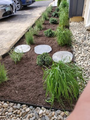 New bed install, plants, mulch, stone, stepping stones.