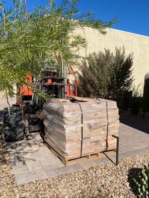 Carefully setting the pallet as close to our work area as possible