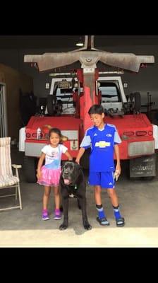 The owner's children Eris and Shiloh hanging out with midnight (the gentle giant) at the shop.