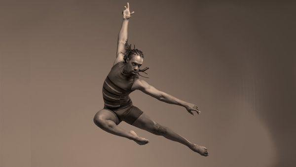 Male dancer leaps in mid air arms outstretched.