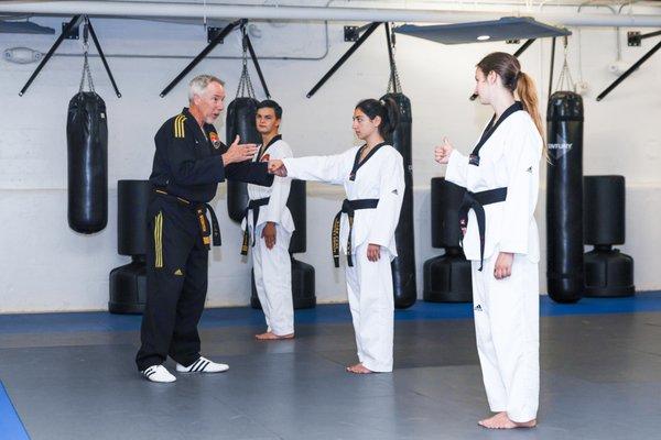 Master Webster details self-defense techniques during a black belt class.