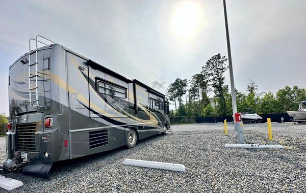 RV parked in large space in Powered Storage & Parking facility in Leland