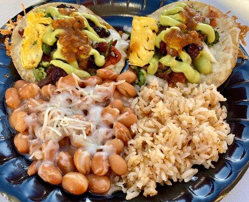 Pastor tacos with cheese and pineapple and side of rice and beans.