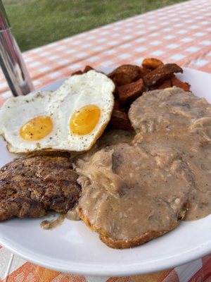 Biscuits and Mushroom Gravy with a side of eggs and sausage.