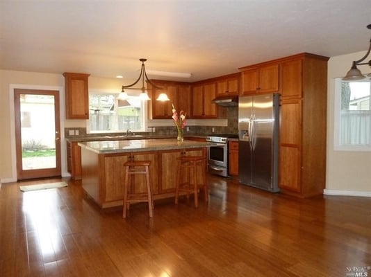 This remodel adds cherry cabinets, granite countertops and bamboo flooring.