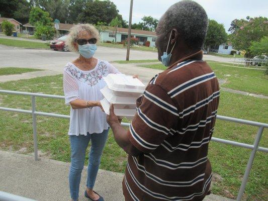 Volunteer teams deliver the hot meals to designated areas.