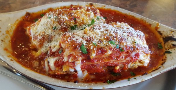 Homemade meat lasagna layered with meat, cheese, ricotta, and homemade sauce, between layers of noodles