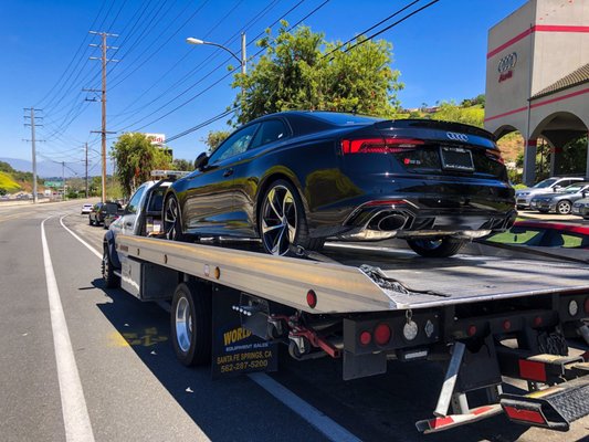 Audi A3 getting delivered to its owner. Here we are using a 4 way tie down to secure the car. We do that by stealing each wheel to the bed.