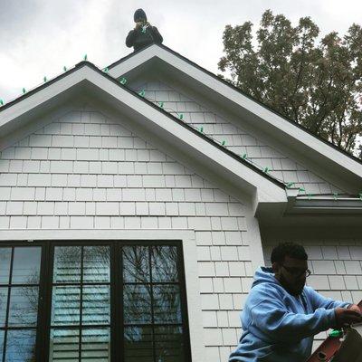 Our team hanging Christmas lights early in October.