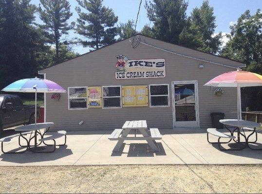 Restaurant front, order window, outdoor seating area.