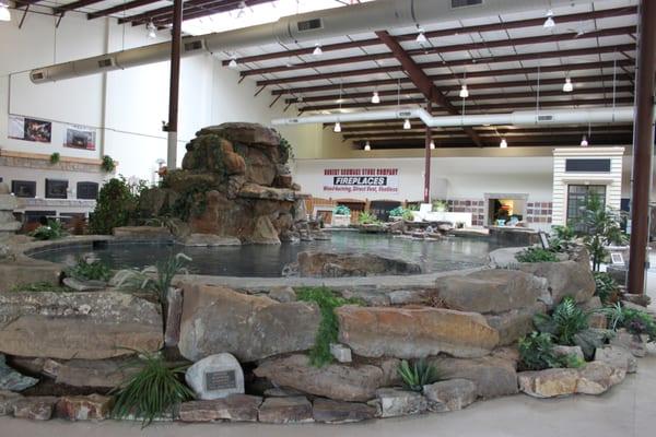 Main show piece of our showroom - large pool with waterfalls & several fountains all surrounded by natural stone