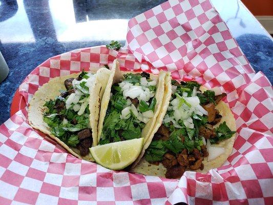 Carne Asada and Al Pastor tacos on homemade tortillas.