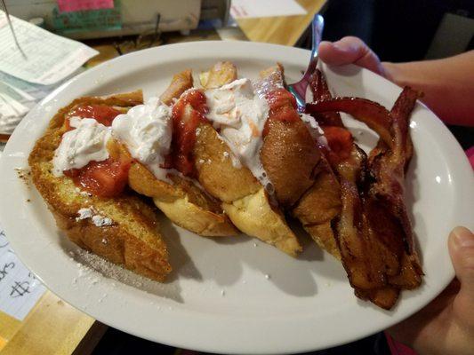 Strawberrys Glazed French Toast topped with whipped cream