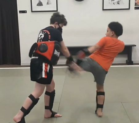 Youth Muay Thai class practicing body kicks!!