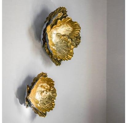 Metal wall flower sculptures by Gold Leaf Design Group