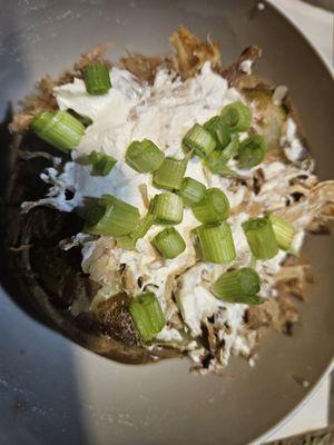 BBQ baked potato with brisket or pulled pork. It comes with butter and cheese with choice of bbq sauce, sour cream, and chives.