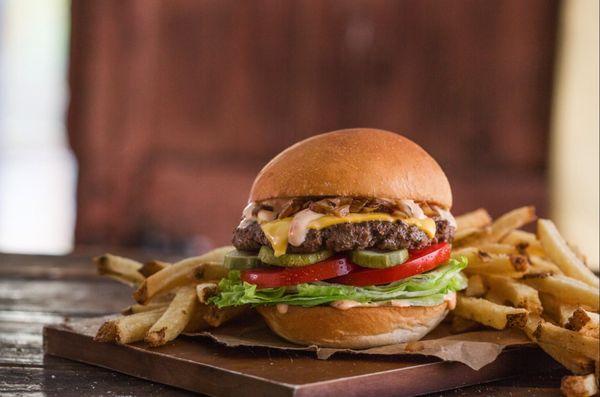 MOOYAH burger piled high with hand-cut fries