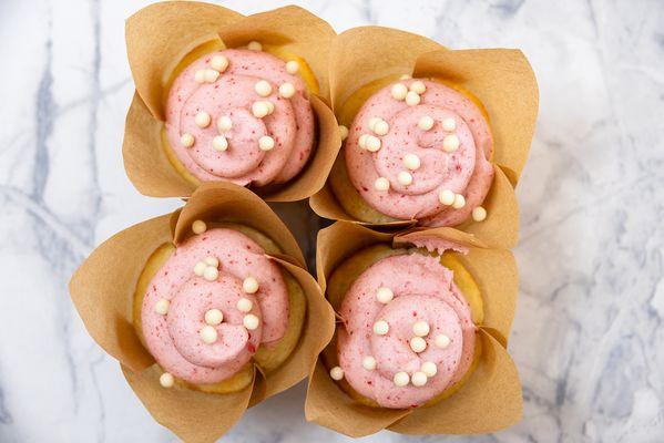 Strawberry 'n Cream: Vanilla bean cupcake with strawberry white chocolate buttercream and white chocolate sprinkles.