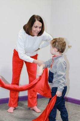 Grandma and grandson exploring new moves with scarves.