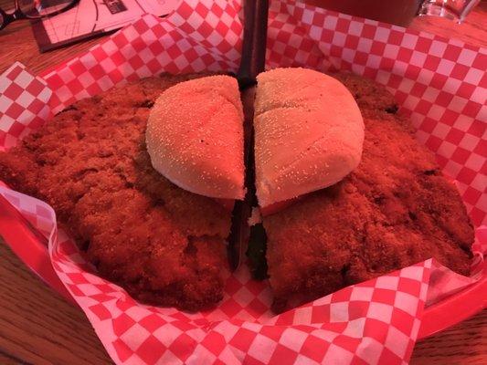 Pork tenderloin sandwich - lighting effect from neon Coors Light sign beside our table