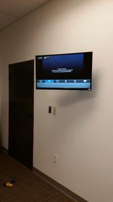 32" Monitor mounted with articulating arm for an office. Wires concealed inside the wall.