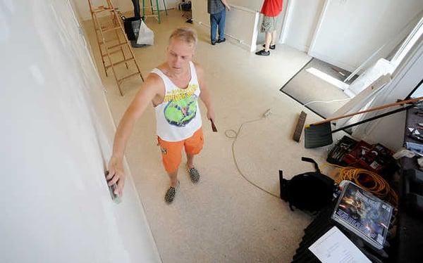 Joe Loubier, partner, getting the walls prepared for reopening of Zimmie's Comics in July 2013.