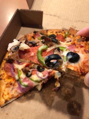 Small Monster's Supreme Pizza. A perfect bite of savory goodness.