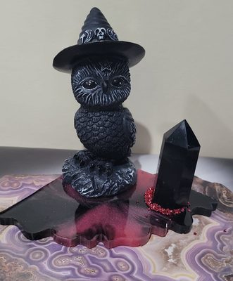 owl with black obsidian point