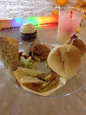 Food served for Minerpalooza VIP (salad, hummus, burger, dinner roll, turkey give gravy, red velvet cupcake, and a Piña Coloda)