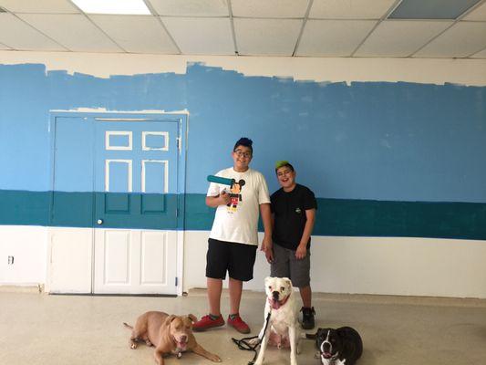 The kids helping paint the Dog House