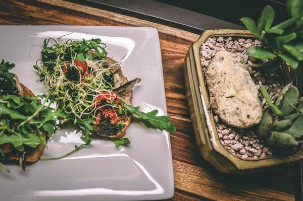 Shiitake Mushroom Toast topped with bean sprouts, roasted tomatoes and kale chips