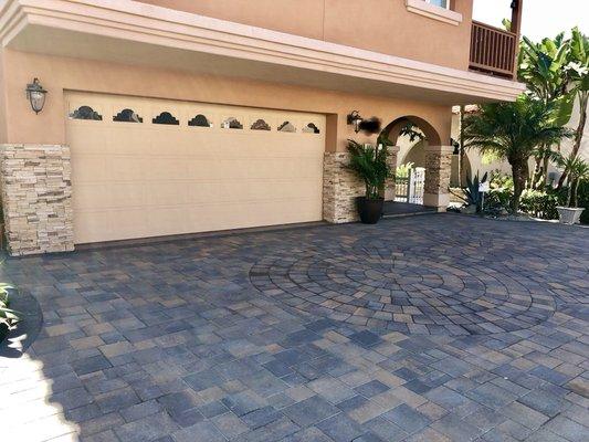 Beautiful new driveway with multiple circle kits overlapping each other and stacked stone veneer