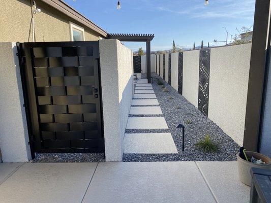 Pool equipment wall screens off unsightly pool equipment at the access side of the house.