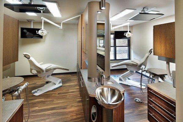 Comfortable treatment rooms with the latest technology and televisions on the ceilings for viewing during procedures.