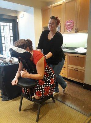 Providing chair massage at the jacklin arts bridal festival