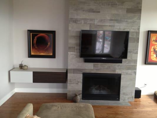 A nice clean TV install over a fireplace.