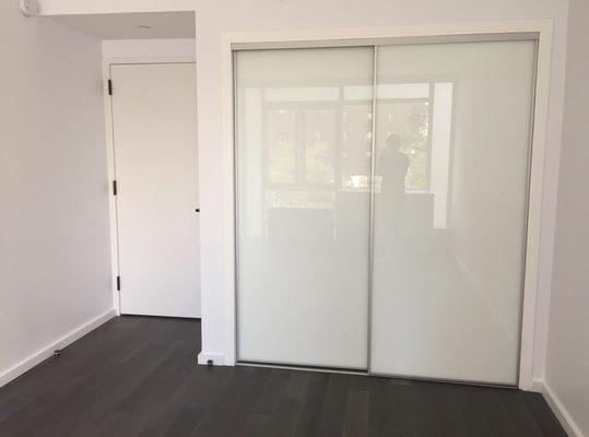 Sliding white glass doors