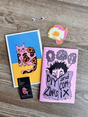 A collection of stickers and zines