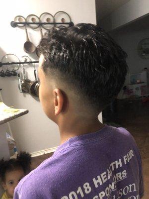 Mid fade with a zero on the sides and a trim on the top.