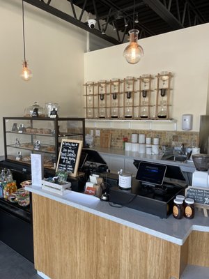 Cold Brew being brewed Case has muffins and juices Checkout