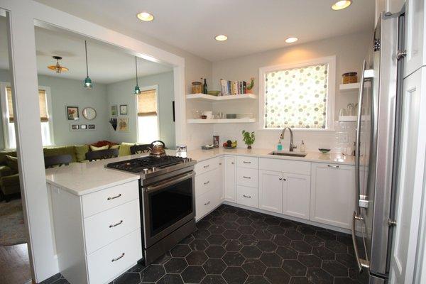 White kitchen with floating shelves.