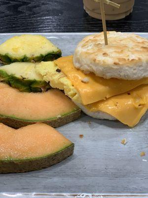 Biscuit egg and cheese sandwich with surprise side of fruit